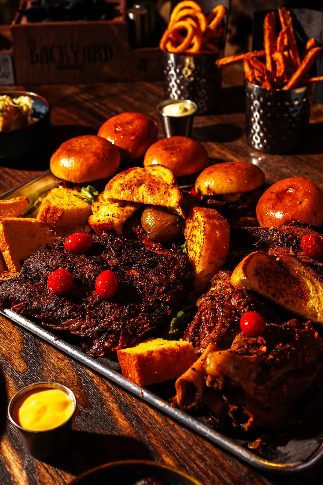 Loaded BBQ platter with sliders and house desserts at Backyard Smokehouse Toronto