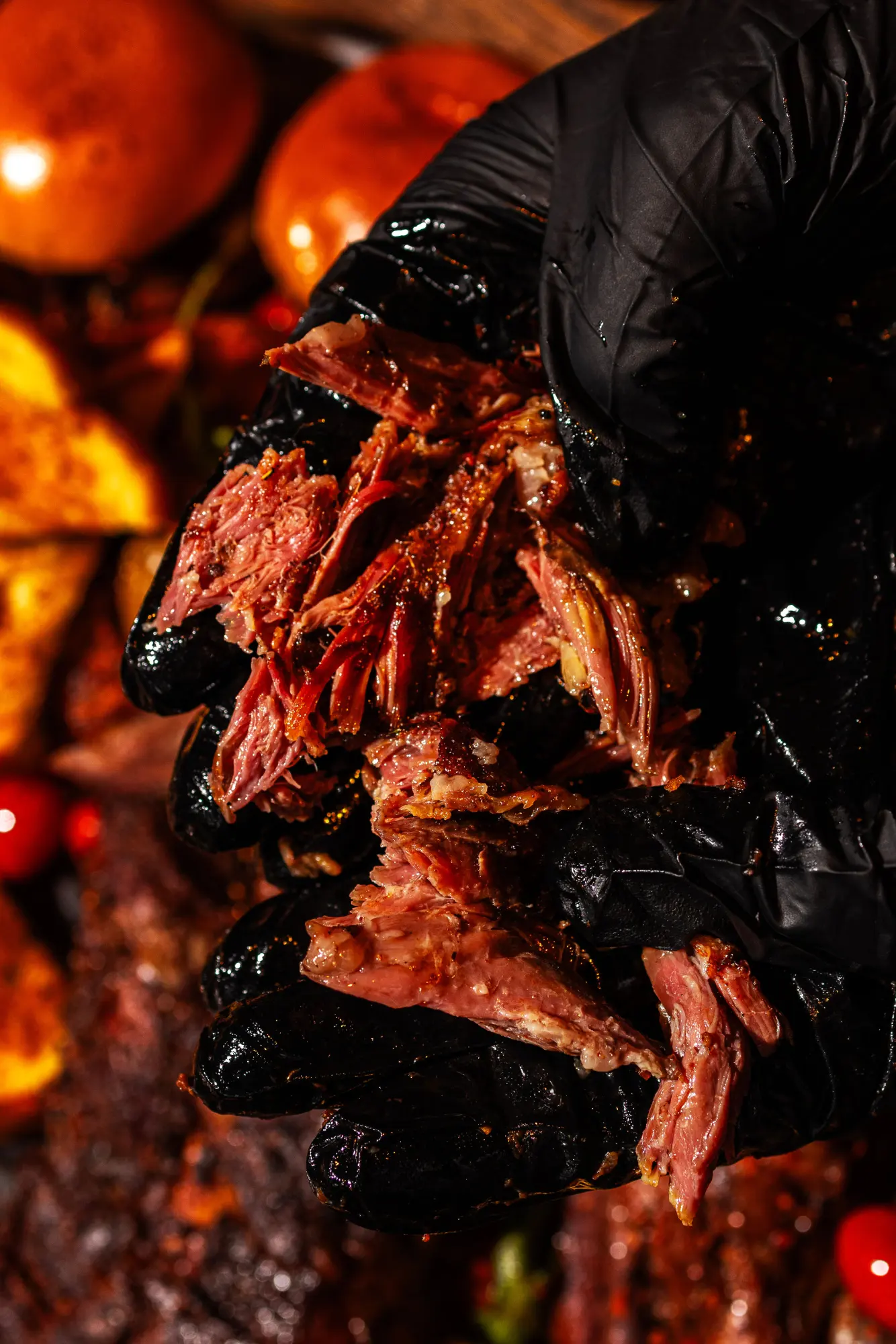 Chef holding tender pulled smoked meat at Backyard Smokehouse Toronto