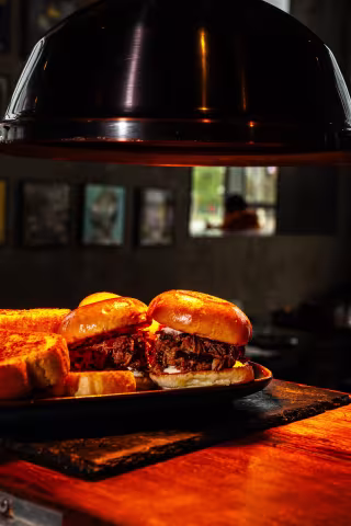 Smoked brisket sliders served on a wooden board at Backyard Smokehouse Edmonton