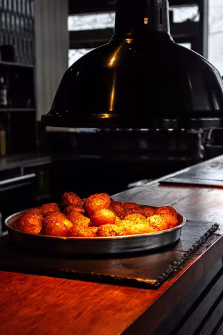 Crispy roasted potatoes under the heat lamp at Backyard Smokehouse Edmonton