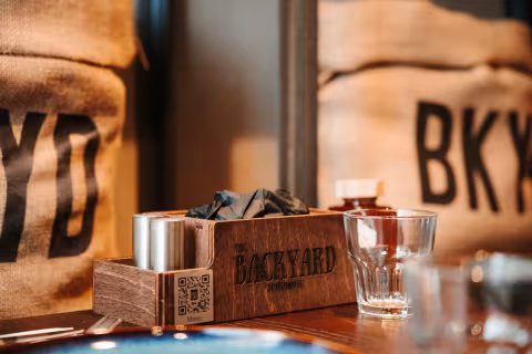 BKYD branded bags and table setting at Backyard Smokehouse Mississauga