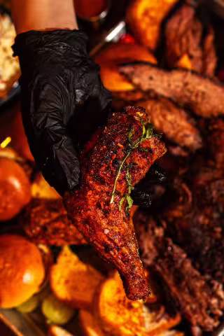 Smoked chicken served over a loaded BBQ platter at Backyard Smokehouse Mississauga