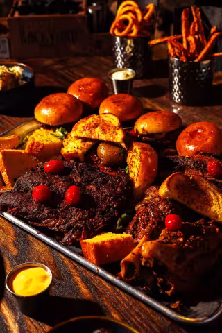 Loaded BBQ platter with sliders and house desserts at Backyard Smokehouse Toronto