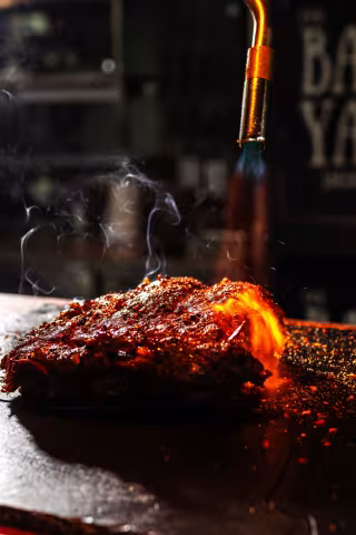 Freshly smoked BBQ ribs glazed and steaming at Backyard Smokehouse Toronto