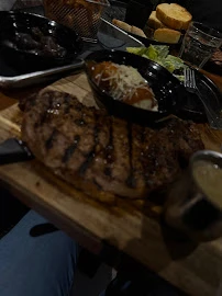 Top-down view of a gourmet steak meal with assorted side dishes and fresh salad.